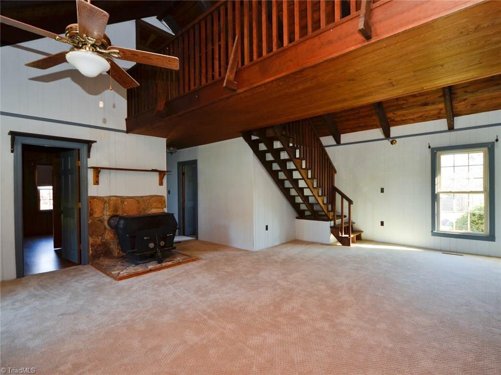 171 Guy Gaither Road Harmony, NC 28634 - Photo 5 of 21 New carpet in living room and dining room combo. Cozy up next to the fireplace.