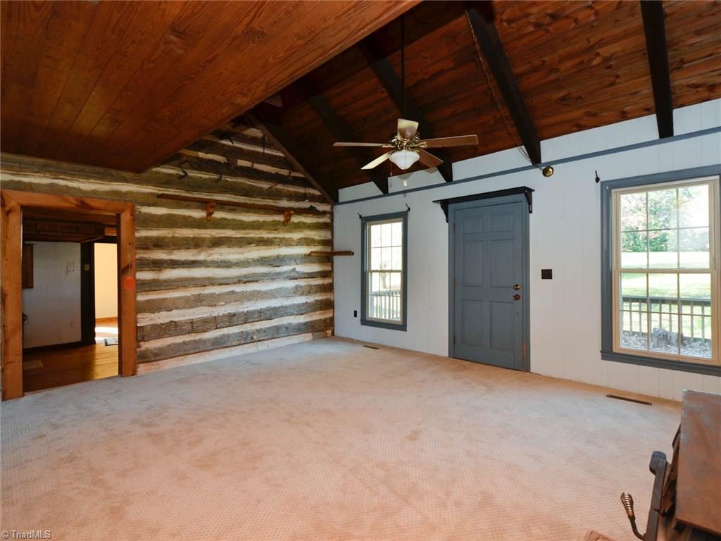 171 Guy Gaither Road Harmony, NC 28634 - Photo 8 of 21 Large windows allow plenty of natural light to shine into the living room.