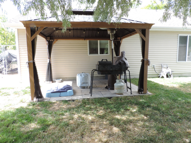 758 South 650 West Logan, UT 84321 - Photo 18 of 18 Freestanding patio gazebo with wood-look posts and a metal roof
