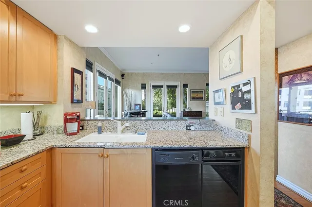 a kitchen with stainless steel appliances granite countertop a sink stove and cabinets
