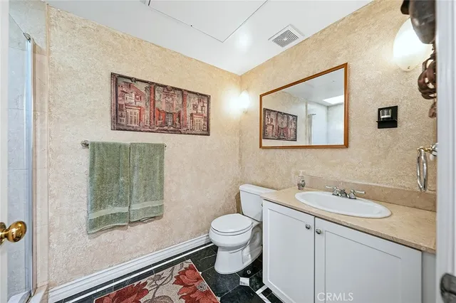 a bathroom with a toilet a sink and a mirror