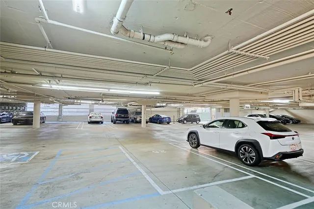 a view of parking garage with cars parked