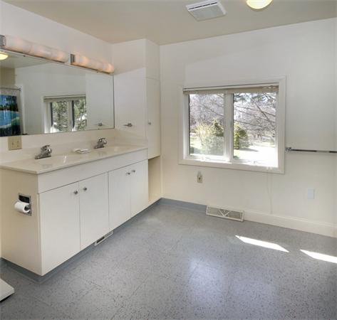 676 Lowell Road Concord, MA 01742 - Photo 11 of 18 a bathroom with a granite countertop sink mirror and window