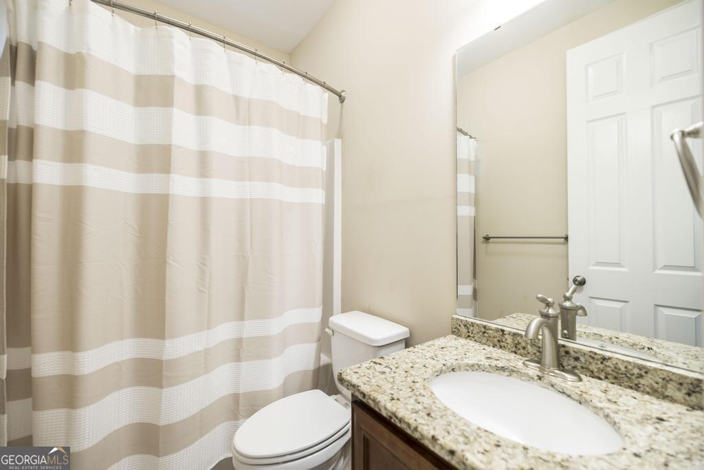 206 Londe Lane Perry, GA 31069 - Photo 22 of 37 a bathroom with a granite countertop sink and a mirror
