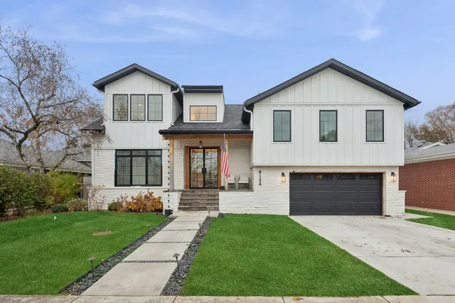 a front view of a house with a yard and garage