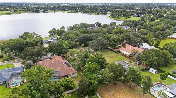 an aerial view of lake residential houses with outdoor space and swimming pool