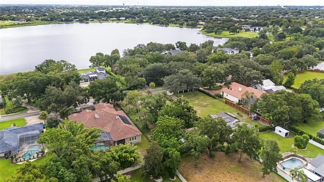 an aerial view of lake residential houses with outdoor space and swimming pool