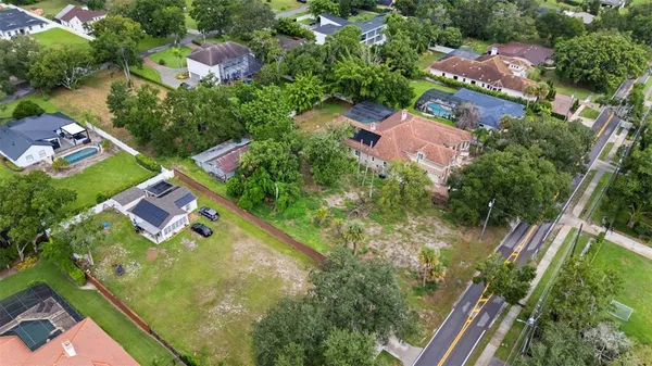 an aerial view of residential house with outdoor space and swimming pool