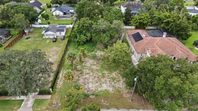 an aerial view of a house with garden space and street view