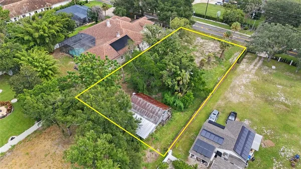 an aerial view of a house with a garden and swimming pool