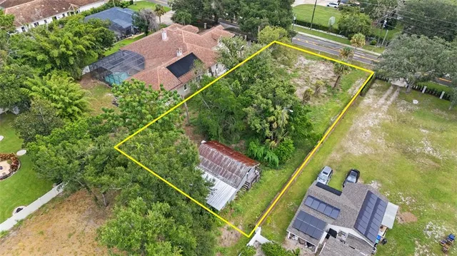 an aerial view of a house with a garden and swimming pool