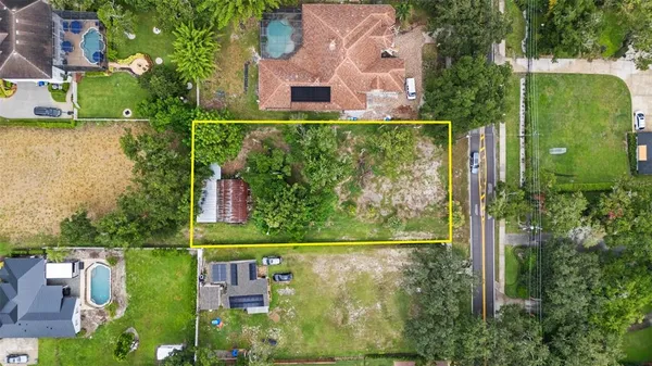 an aerial view of residential house with outdoor space and swimming pool