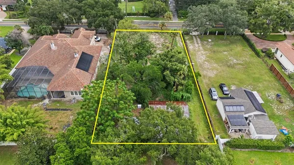 an aerial view of a house with swimming pool and garden