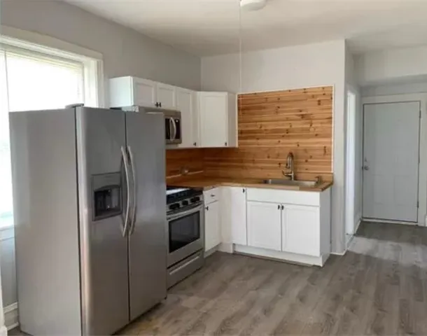 a kitchen with granite countertop a refrigerator and a stove