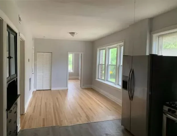 a view of a kitchen with a refrigerator cabinets and a window