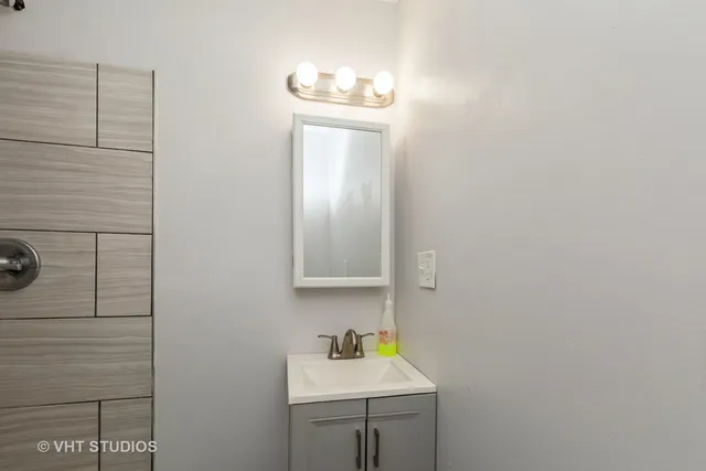 a bathroom with a sink a mirror and vanity