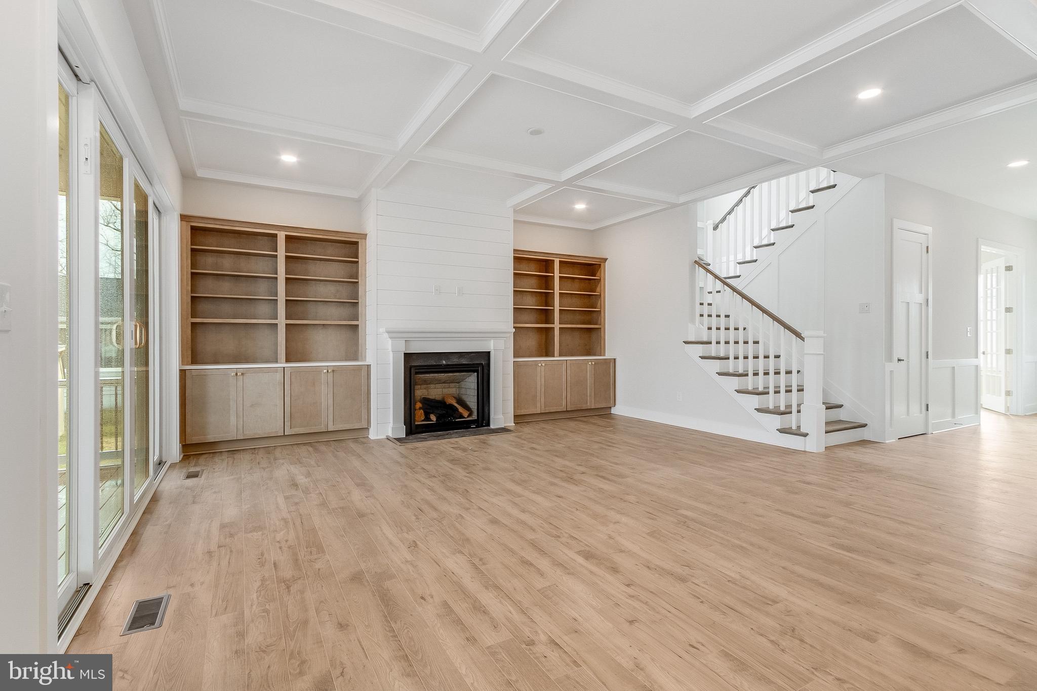 37828 Cedar Road Selbyville, DE 19975 - Photo 31 of 109 an empty room with wooden floor fireplace and windows