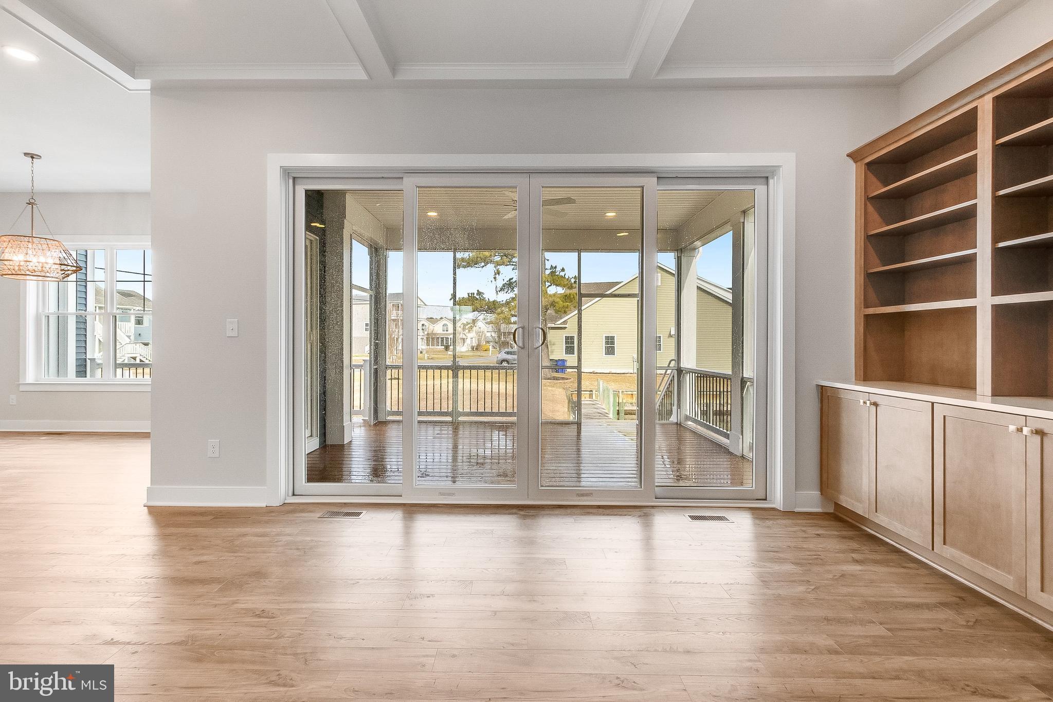 37828 Cedar Road Selbyville, DE 19975 - Photo 38 of 109 a view of an empty room with wooden floor and a window