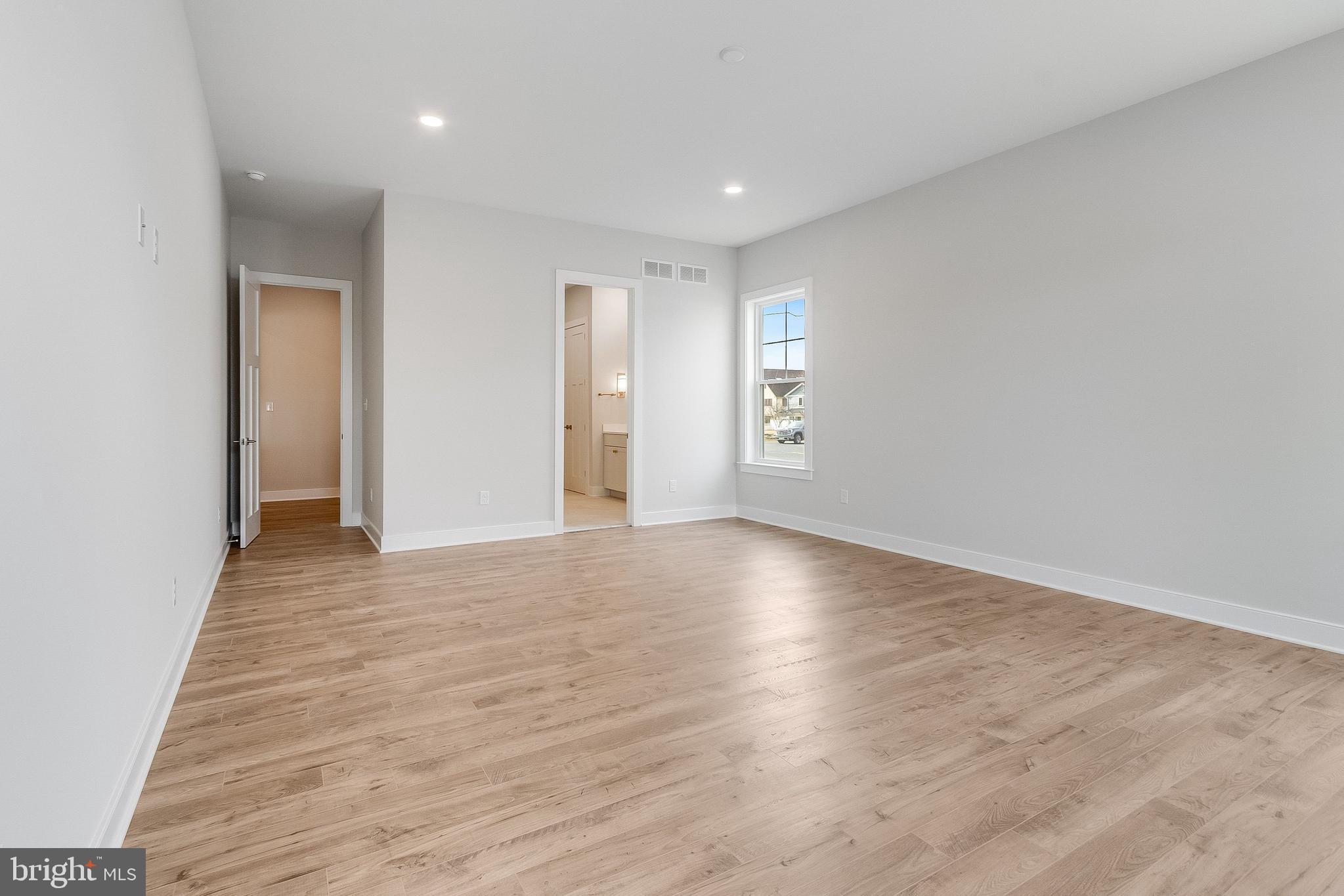 37828 Cedar Road Selbyville, DE 19975 - Photo 49 of 109 an empty room with wooden floor and windows