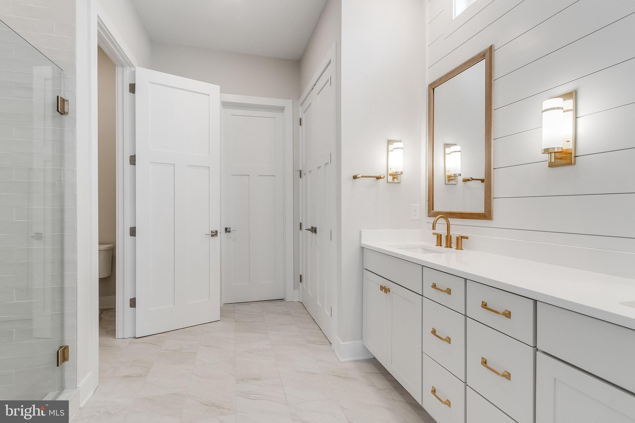 37828 Cedar Road Selbyville, DE 19975 - Photo 58 of 109 a spacious bathroom with a double vanity sink a mirror and a shower