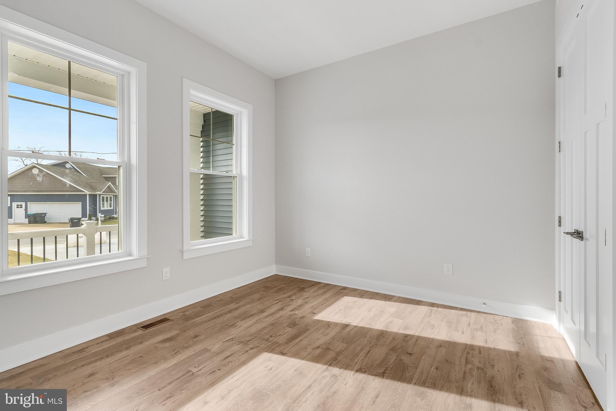 37828 Cedar Road Selbyville, DE 19975 - Photo 59 of 109 an empty room with wooden floor and windows