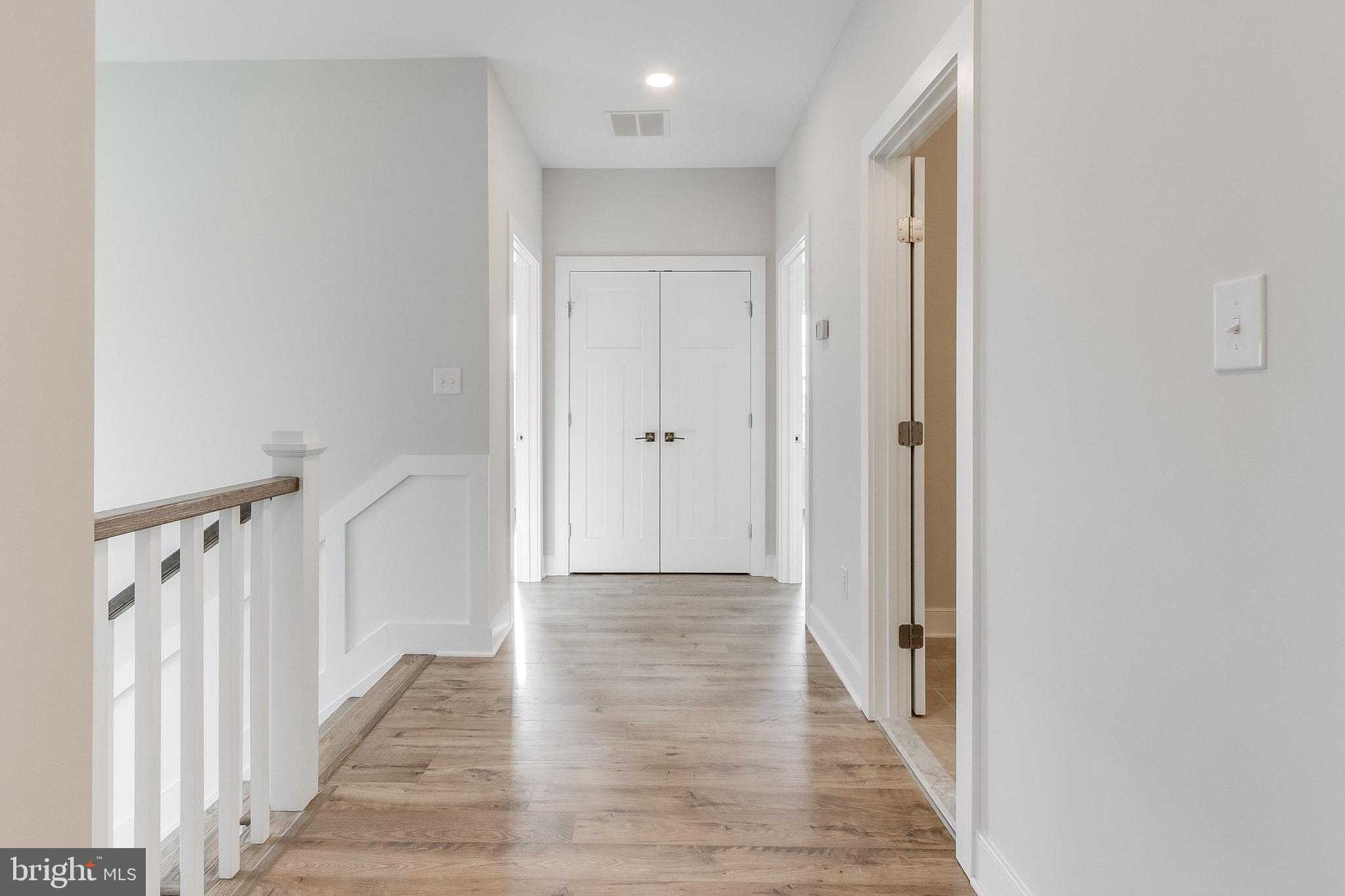 37828 Cedar Road Selbyville, DE 19975 - Photo 74 of 109 a view of a hallway with wooden floor