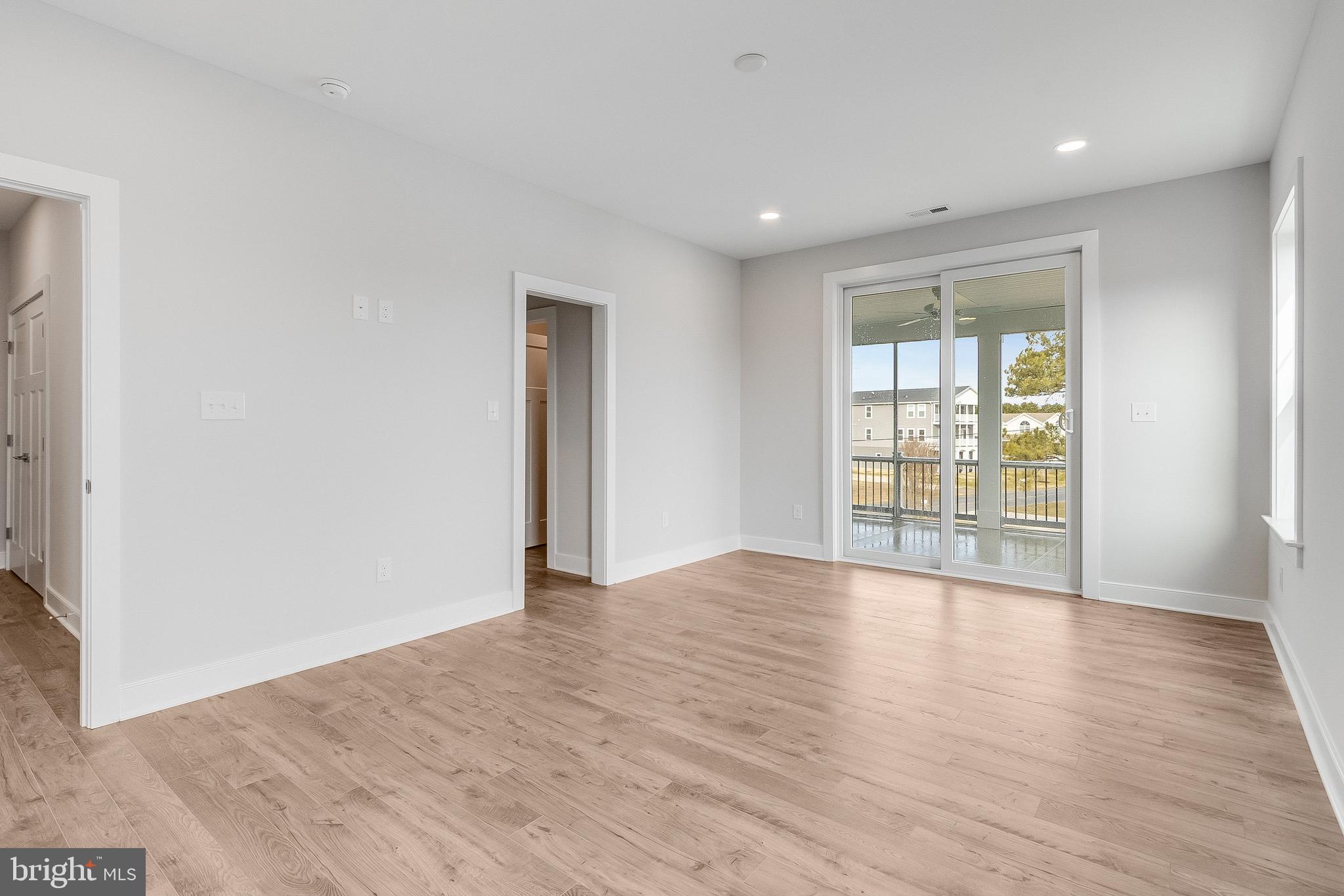 37828 Cedar Road Selbyville, DE 19975 - Photo 76 of 109 a view of an empty room with wooden floor and a window
