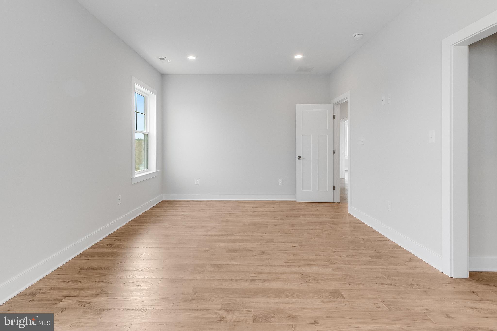 37828 Cedar Road Selbyville, DE 19975 - Photo 77 of 109 a view of an empty room with wooden floor and window