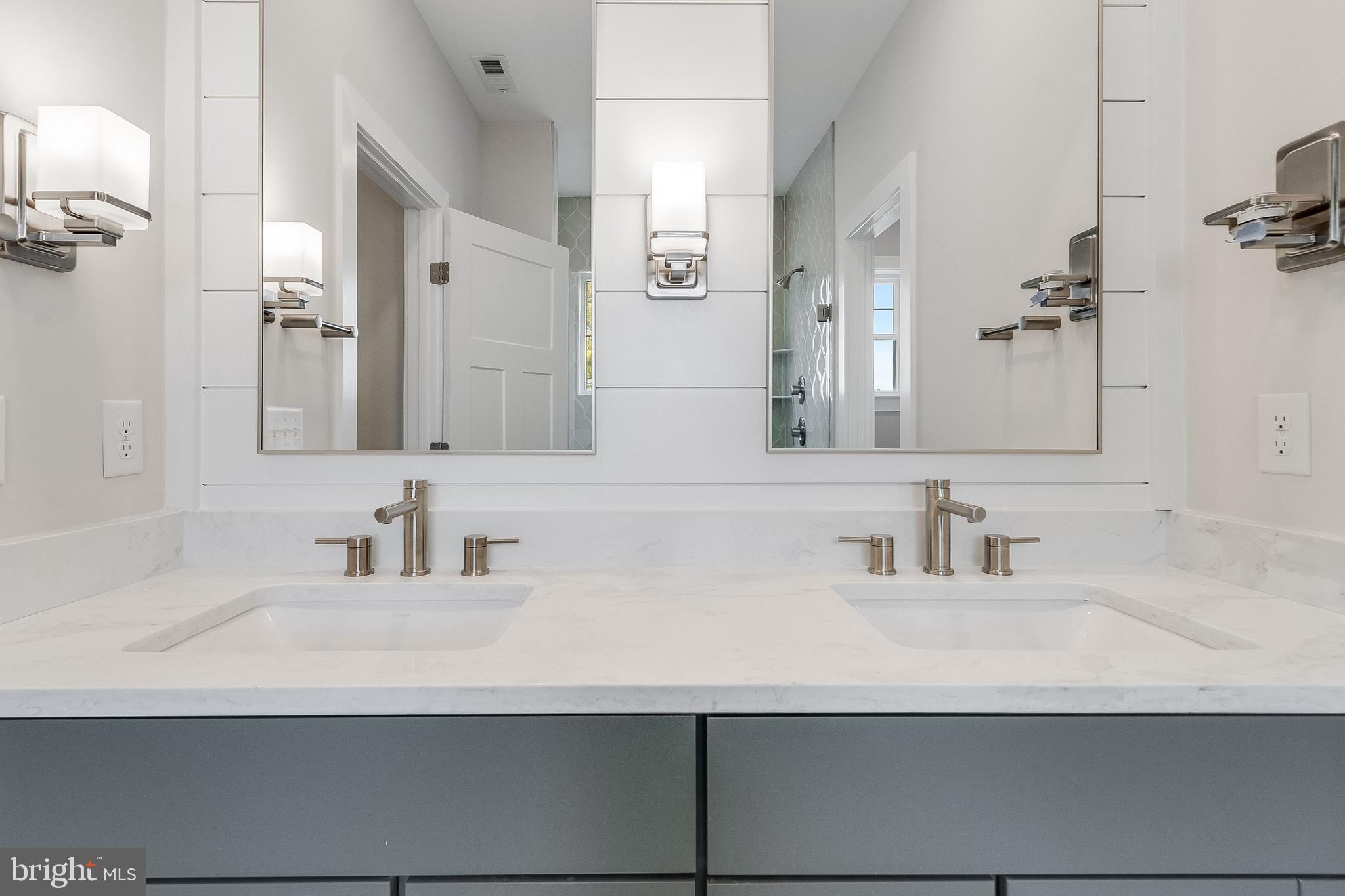 37828 Cedar Road Selbyville, DE 19975 - Photo 82 of 109 a bathroom with double vanity sinks and a mirror