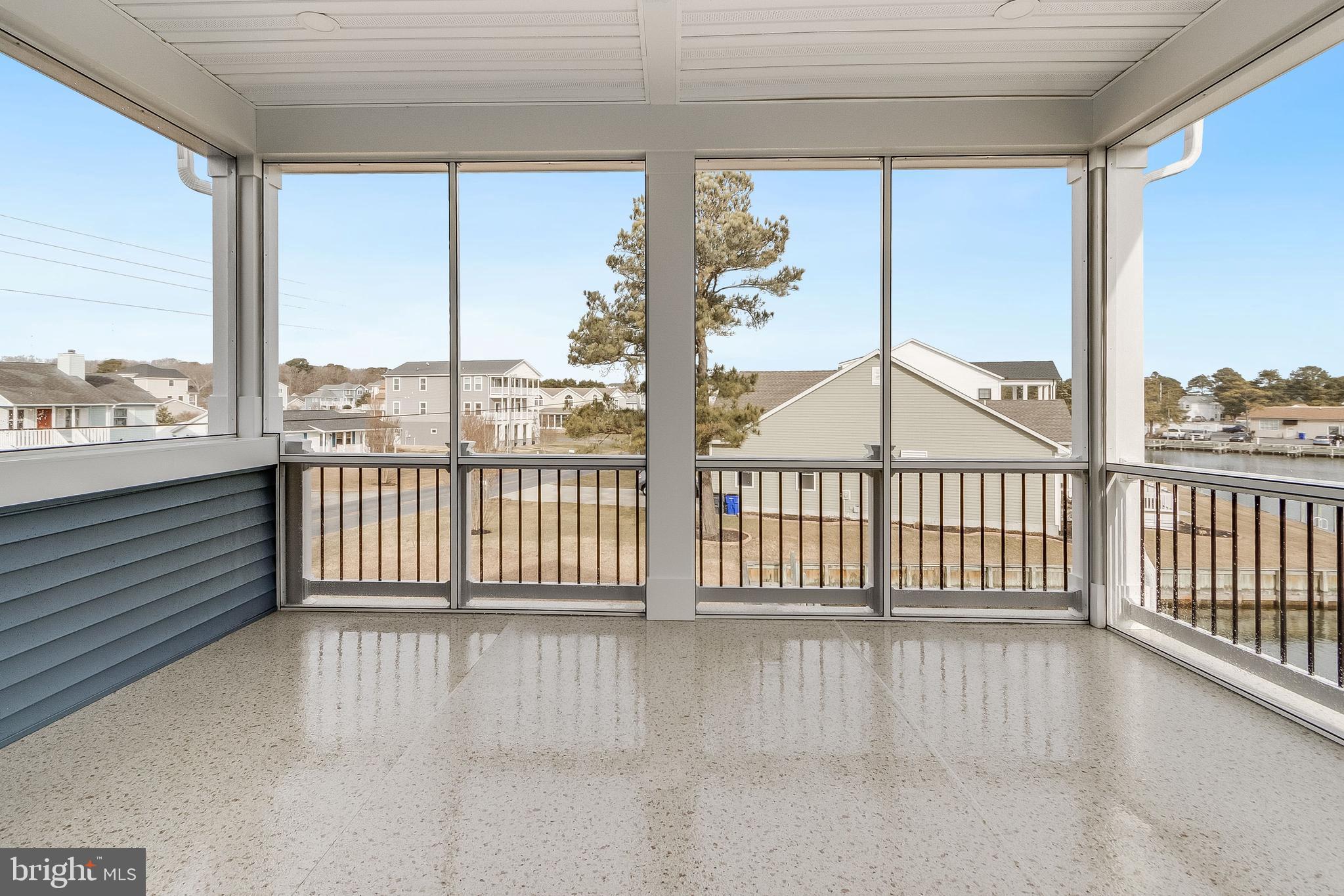 37828 Cedar Road Selbyville, DE 19975 - Photo 86 of 109 a view of a balcony with floor to ceiling windows with wooden floor