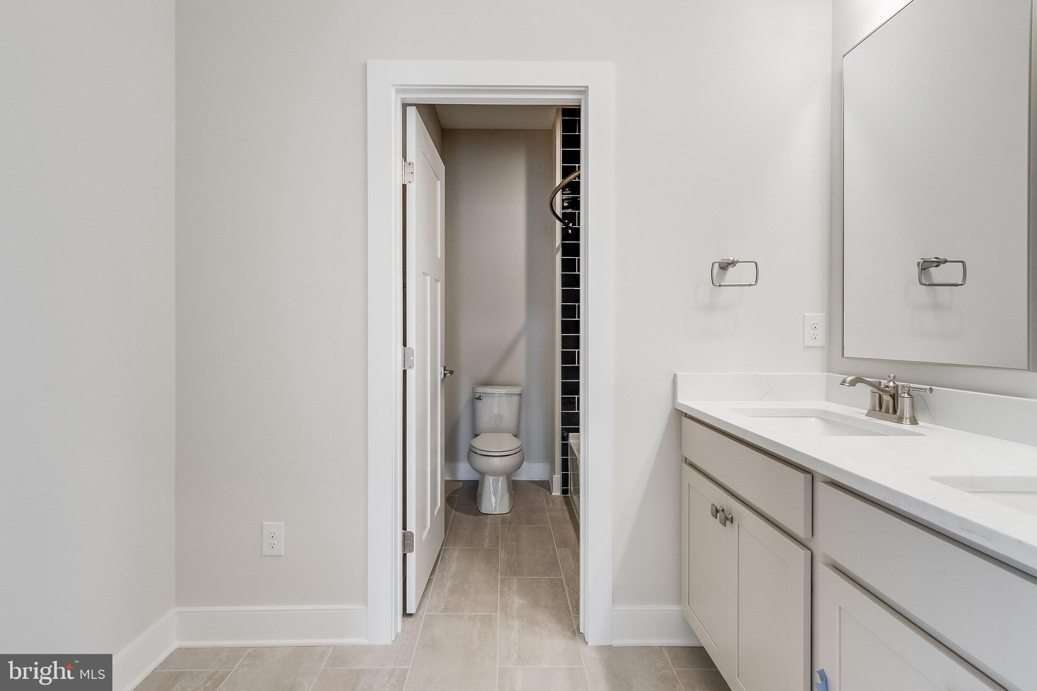 37828 Cedar Road Selbyville, DE 19975 - Photo 96 of 109 a bathroom with a granite countertop sink and a mirror