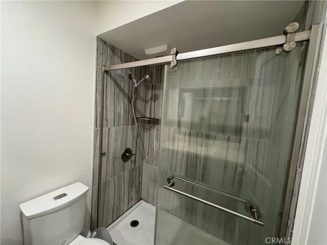 a bathroom with a shower and a toilet