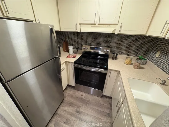 a kitchen with a refrigerator and a stove