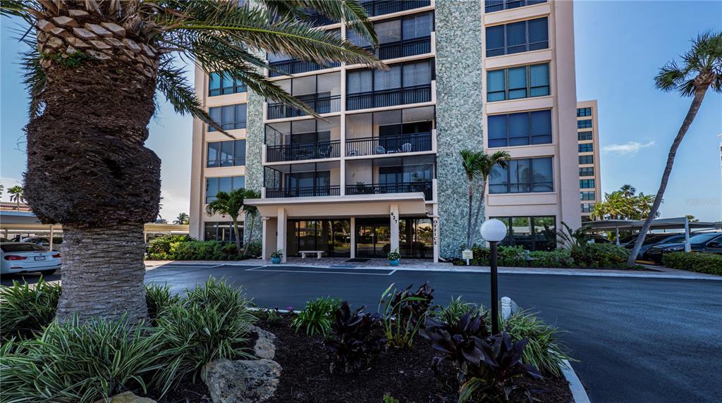 627 Alhambra Road, Unit 701 Venice, FL 34285 - Photo 1 of 1 a view of a building with potted plants