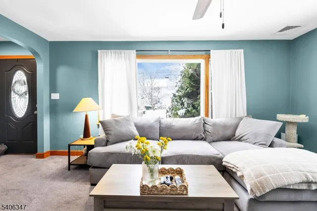 a living room with furniture and a large window