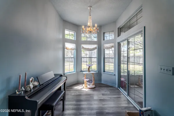a living room with furniture and a chandelier