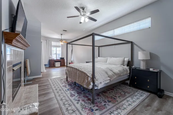 a bedroom with a large bed and a chandelier