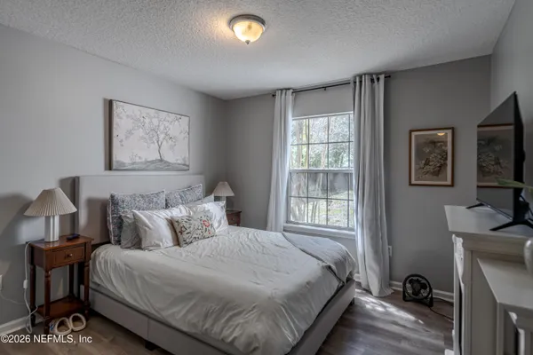 a bedroom with furniture and a window