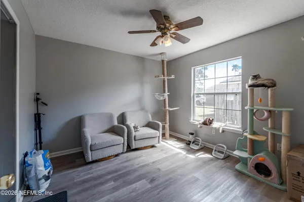 a view of a livingroom with workspace and a window