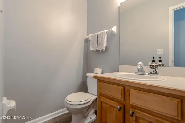 a bathroom with a sink a toilet and mirror