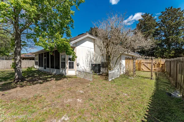a view of a house with backyard and sitting area