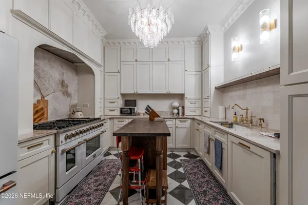 a kitchen with a stove a sink and cabinets