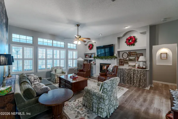 a living room with fireplace furniture and a flat screen tv