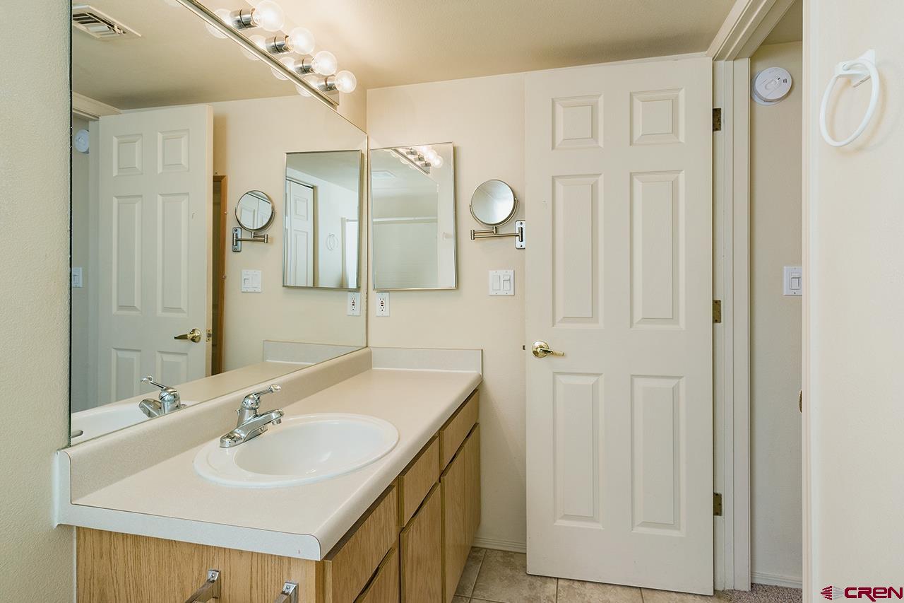 1100 Goeglein Gulch Road, Unit 167 Durango, CO 81301 - Photo 12 of 20 a bathroom with a double vanity sink mirror and shower