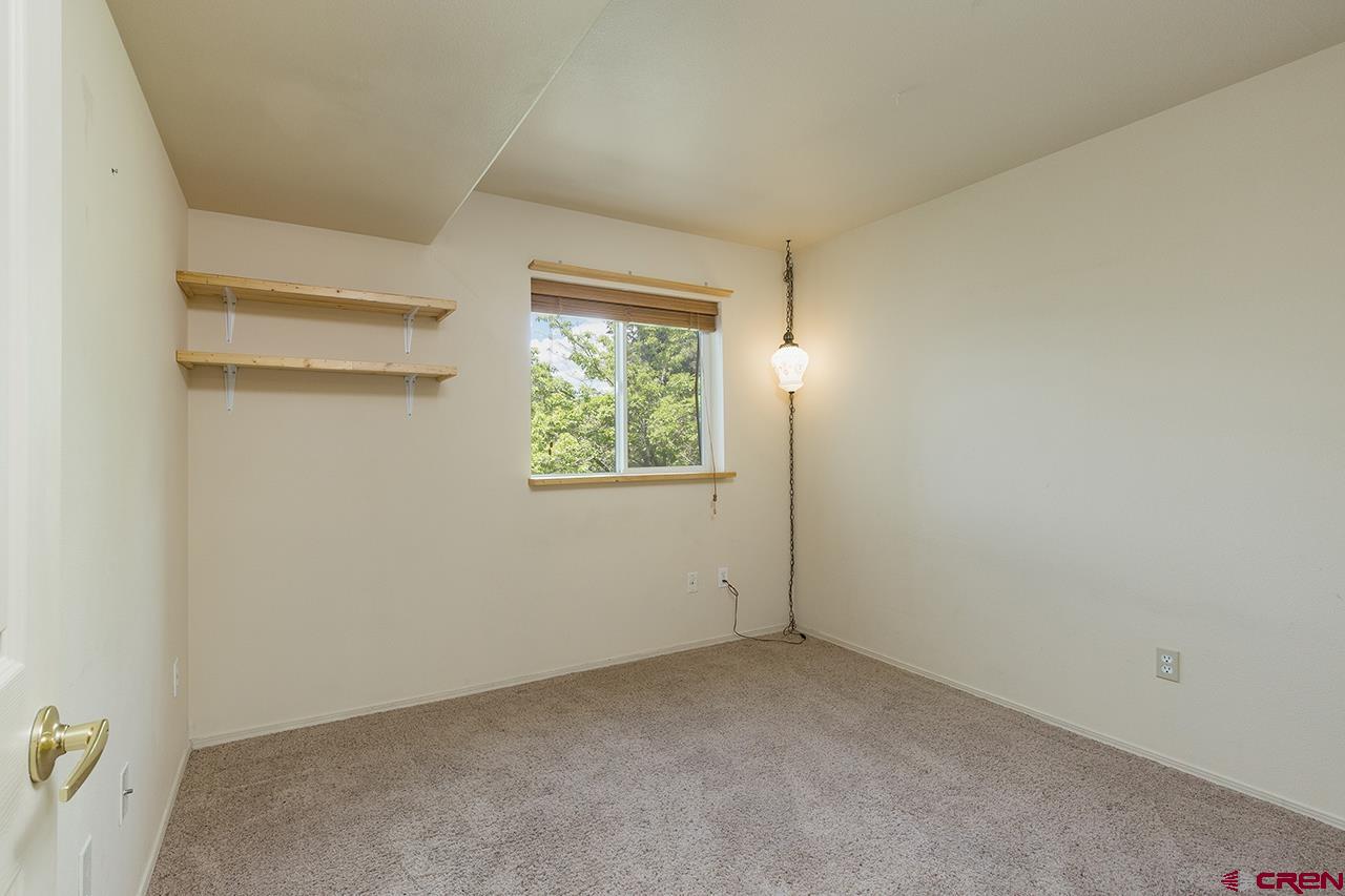 1100 Goeglein Gulch Road, Unit 167 Durango, CO 81301 - Photo 13 of 20 an empty room with windows