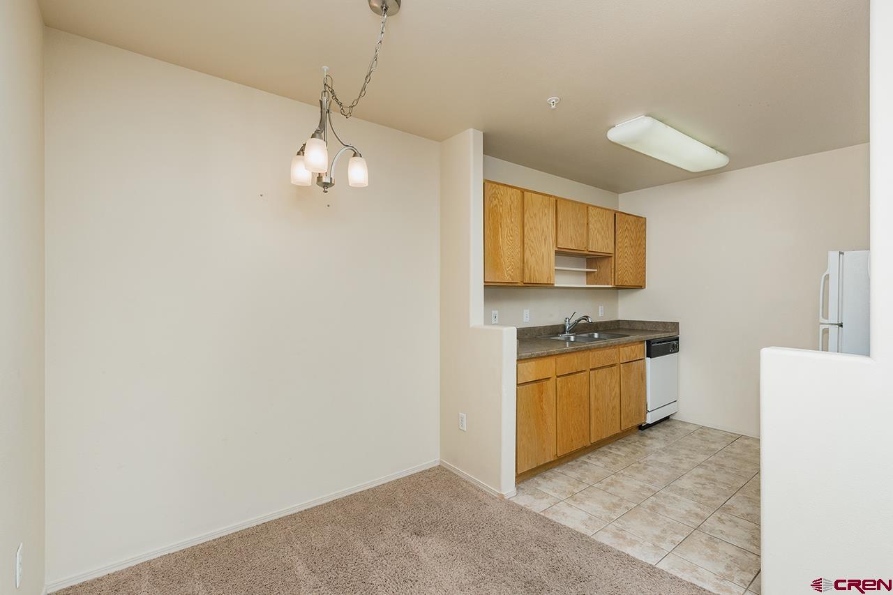 1100 Goeglein Gulch Road, Unit 167 Durango, CO 81301 - Photo 9 of 20 a kitchen with stainless steel appliances granite countertop a sink a stove a refrigerator with grey cabinets