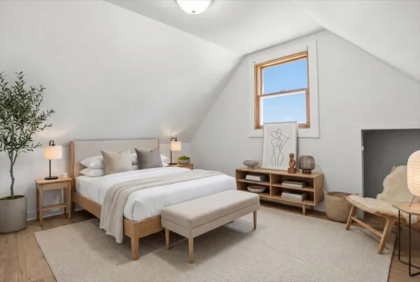 a bedroom with a bed and a potted plant