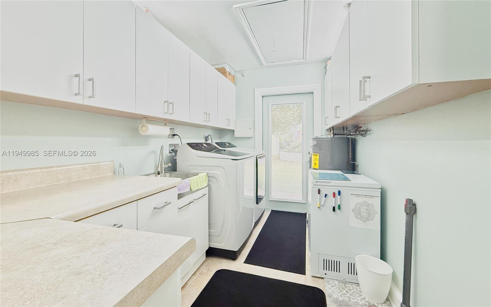 19280 Southwest 304th Street Homestead, FL 33030 - Photo 15 of 57 a utility room with cabinets washer and dryer