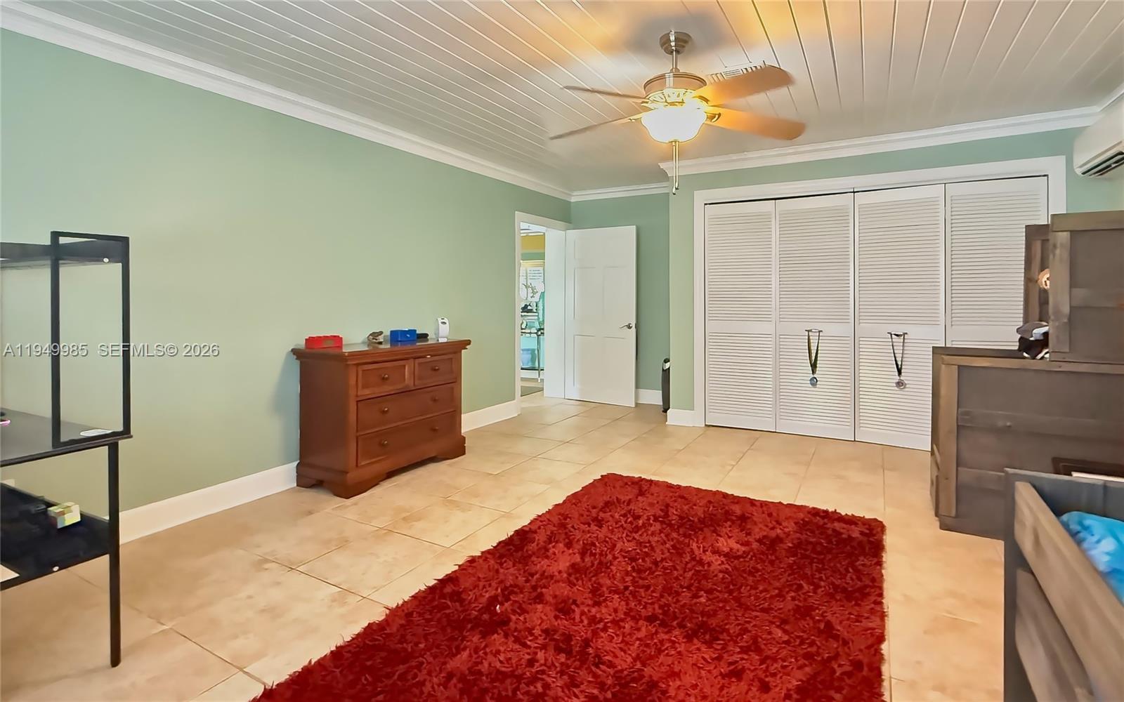 19280 Southwest 304th Street Homestead, FL 33030 - Photo 18 of 57 a living room with a bed furniture and a flat tv screen