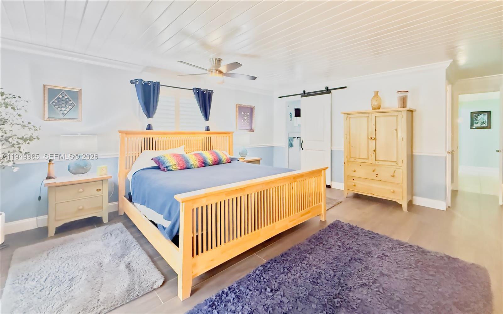 19280 Southwest 304th Street Homestead, FL 33030 - Photo 19 of 57 a bedroom with furniture and wooden floor